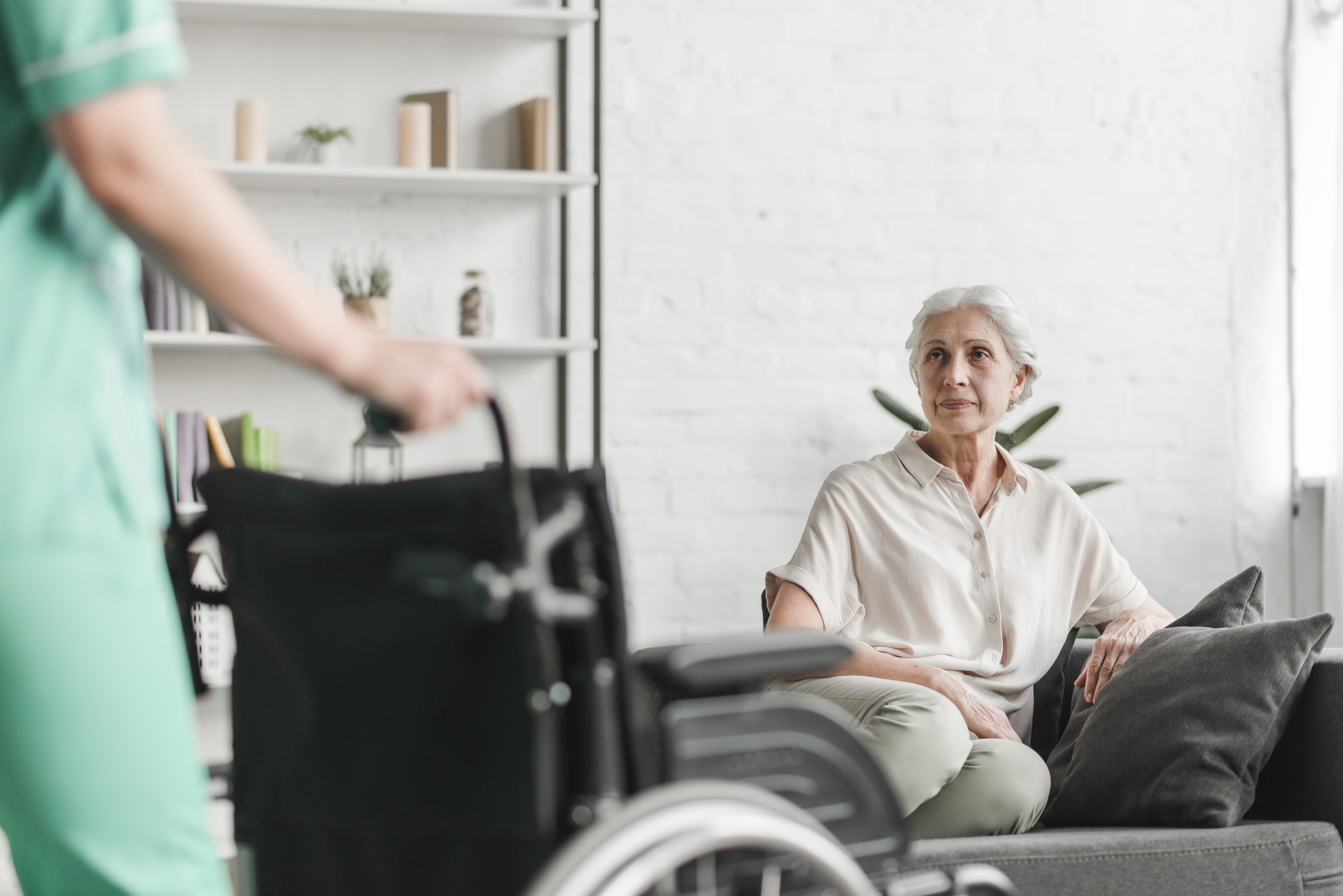 close-up-nurse-holding-wheelchair-front-senior-female-patient
